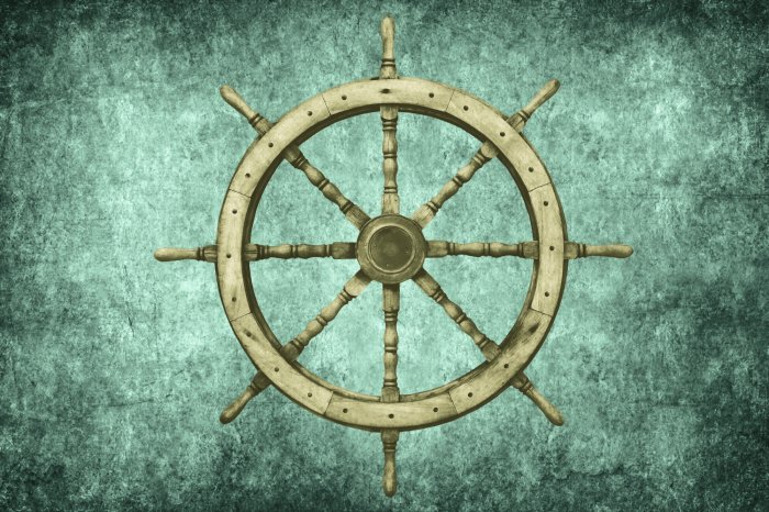 Papier peint  Gouvernail en bois d'un bateau sur fond en béton