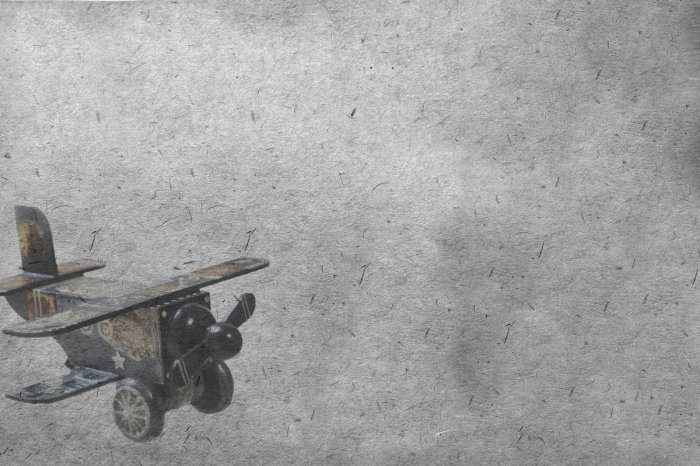 Papier peint  Avion en bois jouet sur fond gris