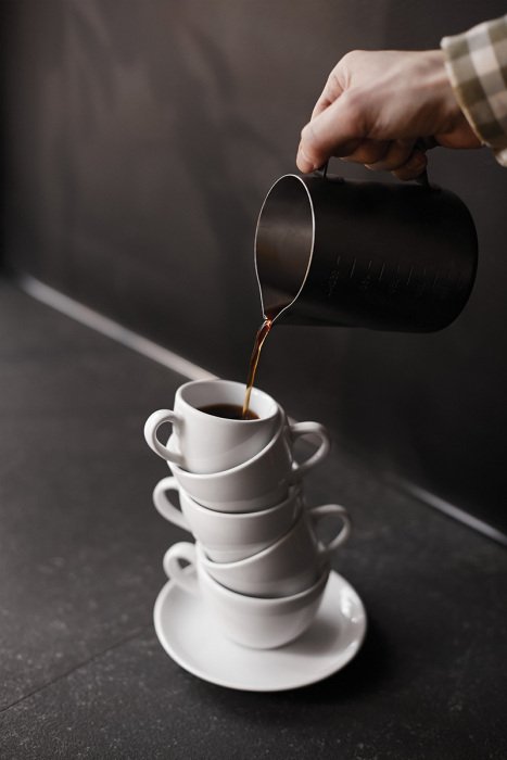 Tableau  Tasses en porcelaine avec du café fraîchement versé
