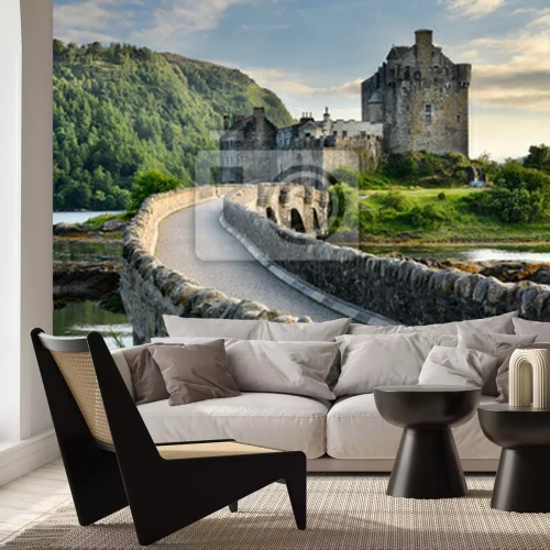 Papier peint  Evening light on restored Eilean Donan Castle on Island at three lochs with added stone arch footbridge Scottish Highlands Scotland UK