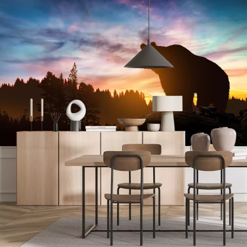 Papier peint  Un ours dans un paysage avec un coucher de soleil en arrière-plan