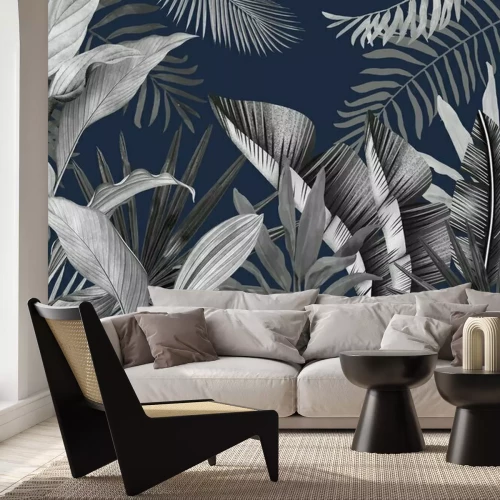 Papier peint  Feuilles tropicales sur fond bleu marine et style grunge.