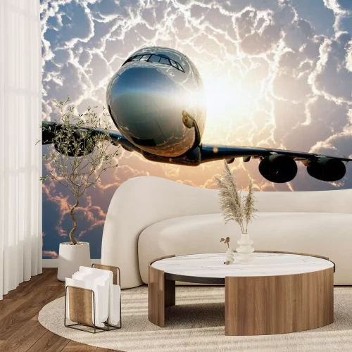 Papier peint  Un avion volant au-dessus des nuages