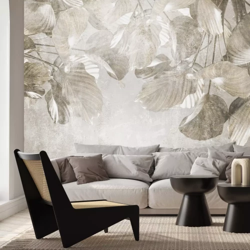 Papier peint  Feuilles tropicales sur béton dans des tons de gris