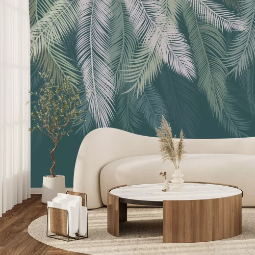 Papier peint  Feuilles de palmier suspendues au-dessus d'un fond vert
