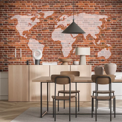 Papier peint  Une carte du monde sur un fond de briques rouges