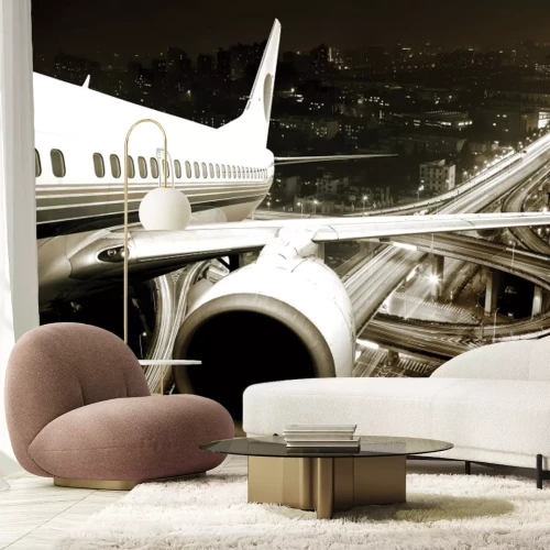 Papier peint  Avion sur fond de paysage urbain la nuit
