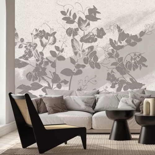 Papier peint  Feuilles grises sur un mur sablonneux