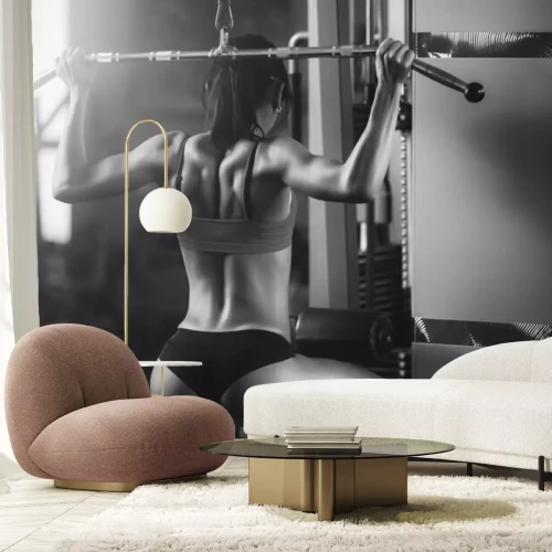 Papier peint  Femme qui s'entraîne sur une machine de fitness