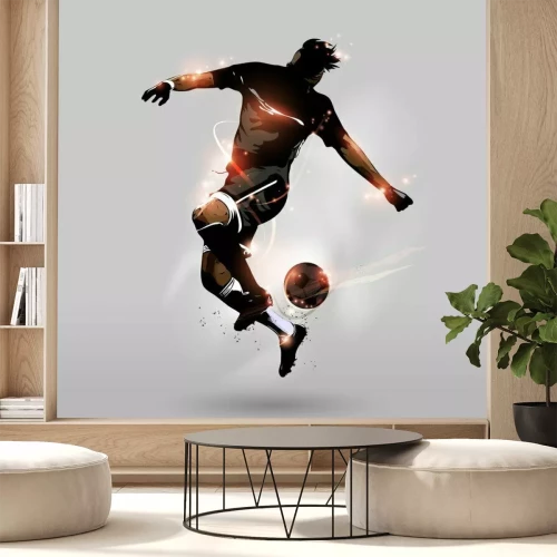 Papier peint  Silhouette d'un footballeur en mouvement dynamique avec un ballon