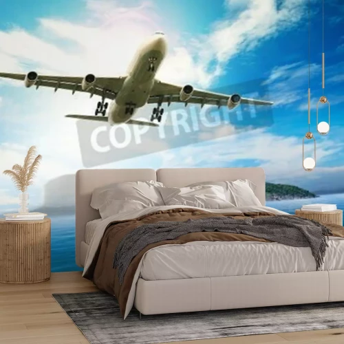 Papier peint  Un avion Vol au-dessus d'une mer bleue et d'une île