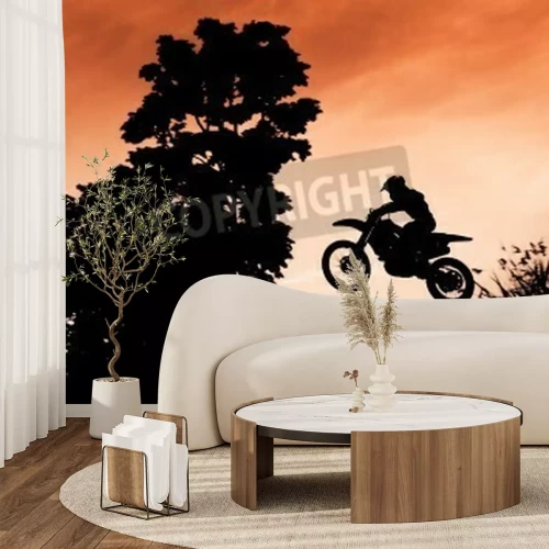 Papier peint  Statut des silhouate saut de motocross sur la lumière ambrée du coucher de soleil fond.