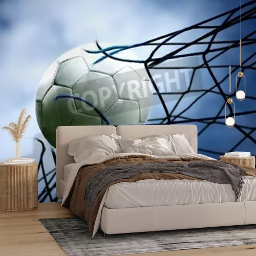 Papier peint  Un ballon de foot déchire le filet