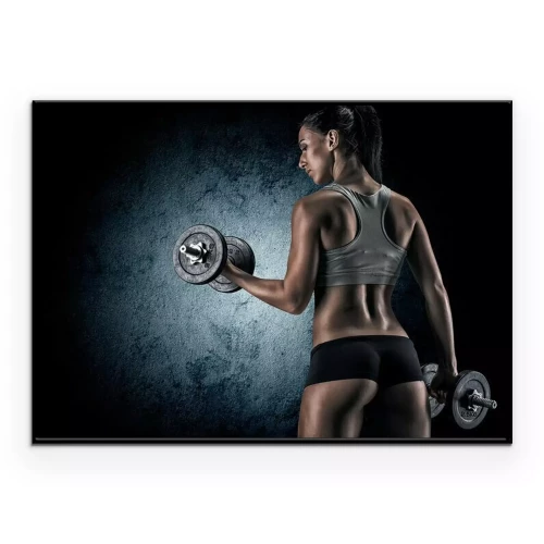 Poster  Femme musclée en studio sur fond sombre
