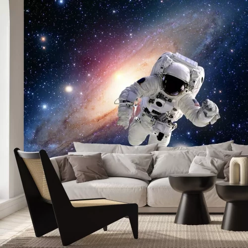 Papier peint  Un astronaute dans l'espace avec une galaxie en arrière-plan